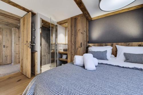 a bedroom with a large bed with white pillows at Residence Les Rives De L Isere - 4 Pièces pour 6 Personnes 574 in Val-d'Isère