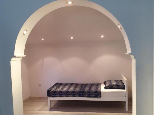 a bed in an archway in a room at Vacation Home Mirasole in Mostar