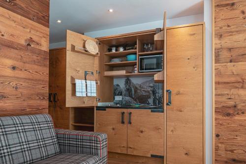 a living room with a couch and wooden walls at Alpen Suites Brandnertal in Brand