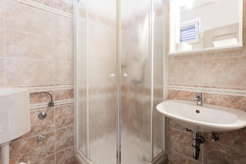 a bathroom with a shower and a sink at Villa Amigo in Podstrana