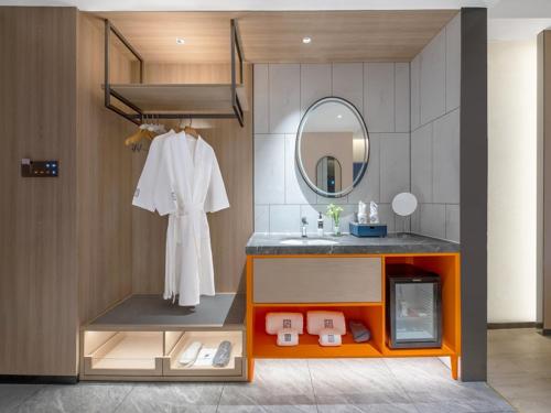 a bathroom with a sink and a mirror at LanOu Hotel Changsha Wuyi Square in Changsha