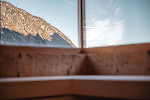 a window with a view of a mountain at Alpen Suites Brandnertal in Brand