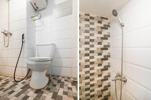 a bathroom with a toilet and a shower at OYO Life 91614 Jarrdin Apartment By Hallo Tidur by Ozi in Bandung