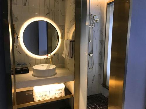a bathroom with a sink and a mirror at LanOu Hotel Xilinhot China Madu Cultural Plaza in Xilinhot