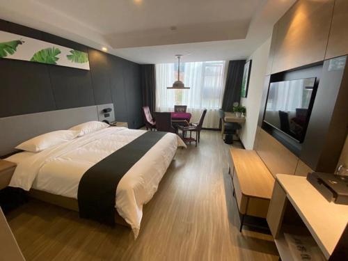 a hotel room with a bed and a television at Thank Inn Chain Yichang Sanxia Airport in Yichang