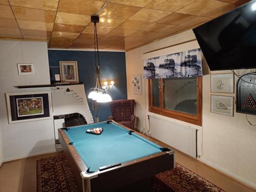 a room with a pool table and a tv at Nina`s GuestHouse, Jämsä City, 160 m2, Include x2 Himos Ski Pass in Jämsä