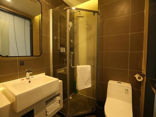 a bathroom with a toilet and a sink and a shower at Thank Inn Chain Beijing Fanshan Chengguan Town Fangshan Red Scarf Park in Fangshan