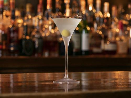 a martini glass sitting on top of a bar at Nagoya Kanko Hotel in Nagoya