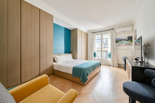 une chambre d'hôtel avec un lit et un canapé dans l'établissement Gorgeous Paris Eiffel Tower - Champs Elysées, à Paris