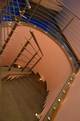 an overhead view of a spiral staircase in a building at Hotel Garnì Carpe Diem in Vigo di Fassa