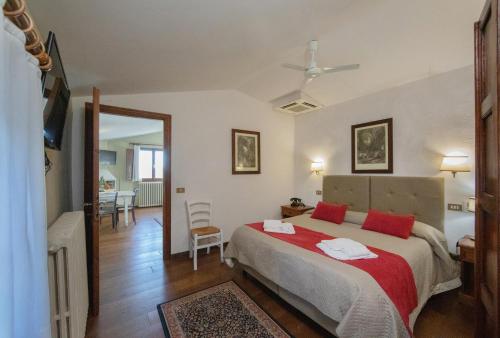 a bedroom with a large bed with red pillows at Tenuta Decimo - Villa Dini in San Gimignano