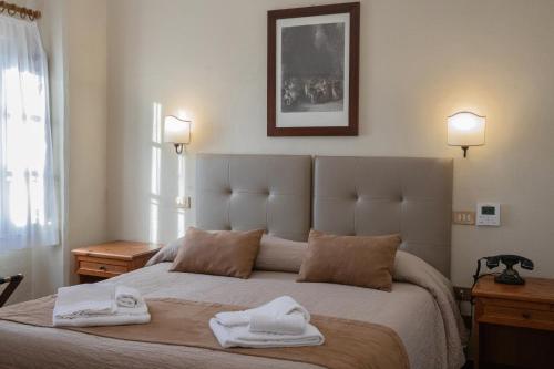 a bedroom with a large bed with towels on it at Tenuta Decimo - Villa Dini in San Gimignano