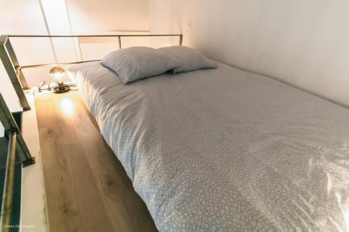 une chambre avec un lit avec un oreiller dessus dans l'établissement T1 Cocon prox. Gare/Métro, commerces, Lyon centre, à Villeurbanne