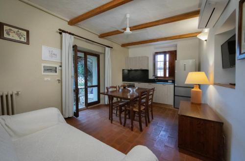 a living room with a table and a kitchen at Tenuta Decimo - Villa Dini in San Gimignano