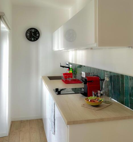 une cuisine avec un comptoir et un appareil rouge dans l'établissement Les Toits de la Canebière - Studio tout confort, à Marseille