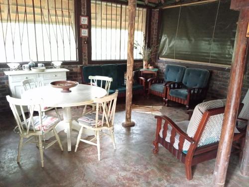 a dining room with a table and chairs at Hedgehog Cabin in Marloth Park