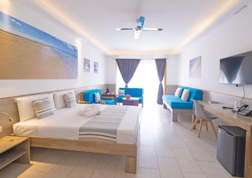 a bedroom with a large bed and blue chairs at Sobrado Boutique Hotel in Santa Maria