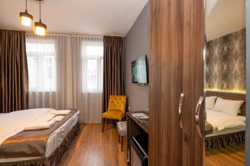A bed or beds in a room at Boutique Central Taksim