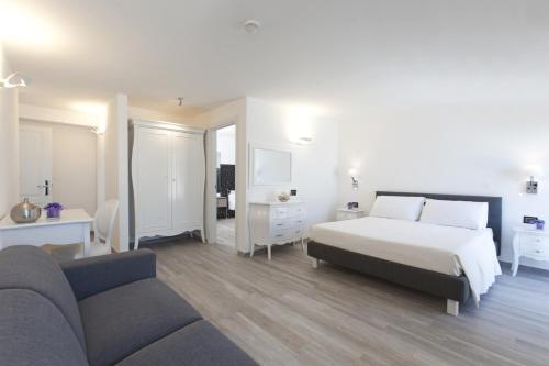 a bedroom with a bed and a couch at Hotel Villa Domizia in Porto Santo Stefano
