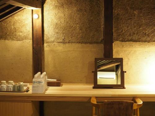 a counter with a mirror on top of a table at NIPPONIA HOTEL 伊賀上野 城下町 in Iga