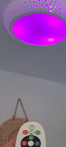 a pink light on a ceiling with a remote control at Final step in Skiathos Town