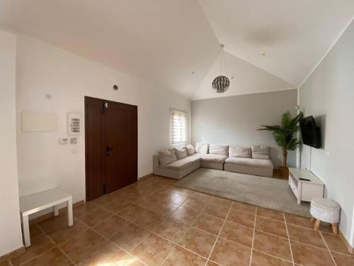 a living room with a couch and a table at El Olivar Corralejo Sun & Beach in Corralejo