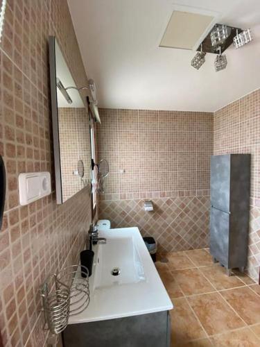 a bathroom with a sink and a mirror at El Olivar Corralejo Sun & Beach in Corralejo