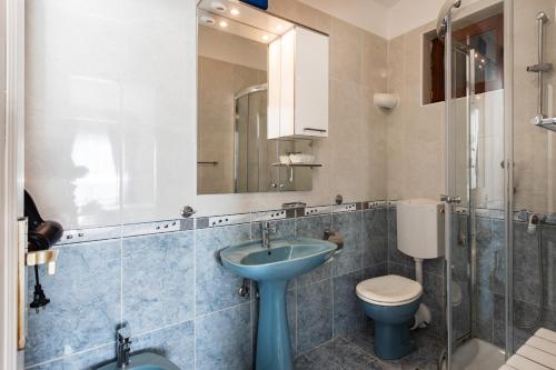 a bathroom with a sink and a toilet and a mirror at Villa Amigo in Podstrana