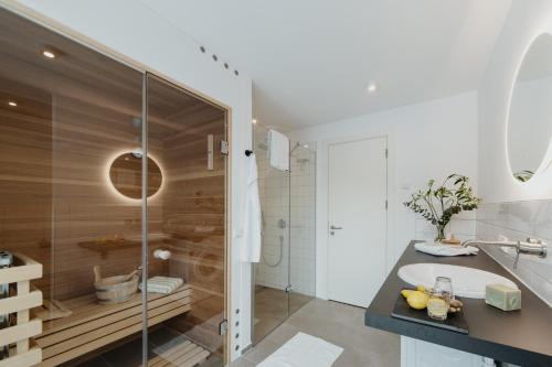 a bathroom with a shower and a sink and a tub at Aloha Pruchten in Pruchten