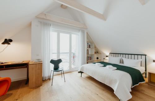 a bedroom with a bed and a desk and a chair at Aloha Pruchten in Pruchten