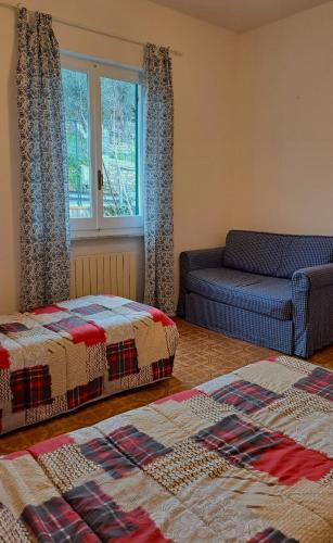 a living room with two beds and a couch at AAUT IL NOCE LEIVI codice CITRA 010029-LT-0025 in Leivi