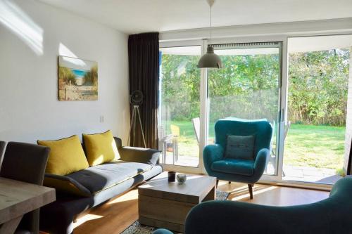 a living room with a couch and a chair at Appartement Badhotel 301 in Callantsoog