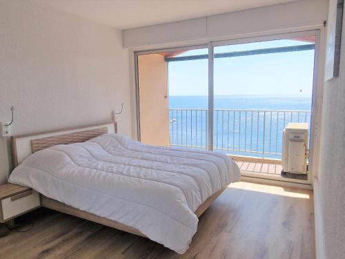 une chambre avec un lit et une grande fenêtre dans l'établissement Appartement T3 à Banyuls, climatisé, proche plage - FR-1-309-281, à Banyuls-sur-Mer
