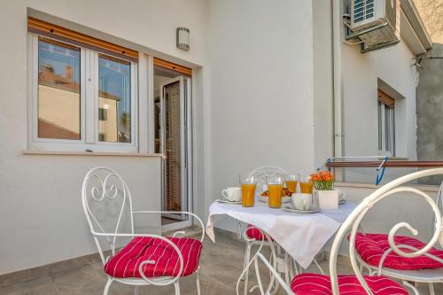 a table with chairs and drinks on a patio at Happy Home - Rental Residence in Split