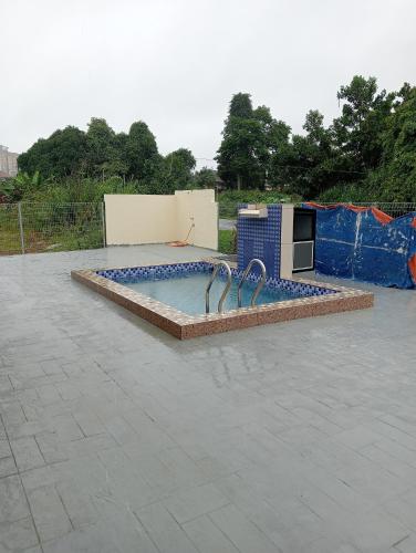 a swimming pool with a fountain in a yard at Tulz Homestay @ Melaka in Malacca