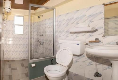 a bathroom with a toilet and a sink at Keerong Cottages Lachung in Lachung