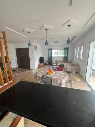 a living room with a black table and a couch at BH villa in Houmt Souk