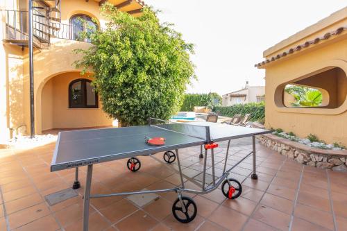 a ping pong table sitting on a patio at Villa Mandarina - Costa CarpeDiem in Calpe