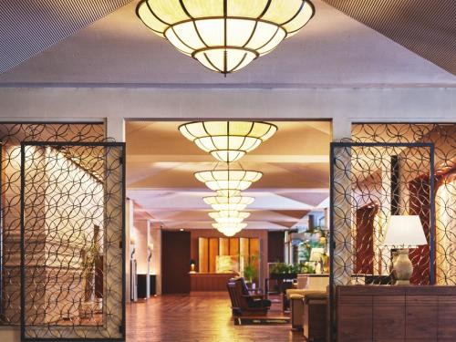 a lobby with large chandeliers hanging from the ceiling at Nagoya Kanko Hotel in Nagoya