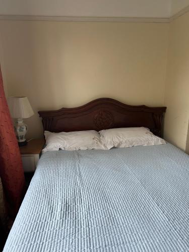 a bedroom with a large bed with a wooden headboard at Greenwich house in London