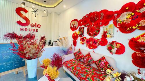 a store with red decorations on a wall at Sele House in Hà Tiên