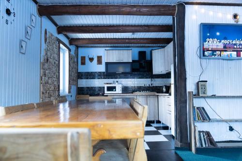 a kitchen with a wooden table in a room at 7+я in Verkhovyna