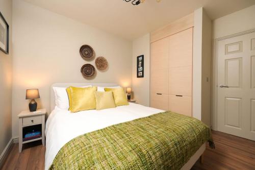 a bedroom with a large white bed with yellow pillows at Stylish Flat With Sofa Bed in Malmesbury! in Malmesbury