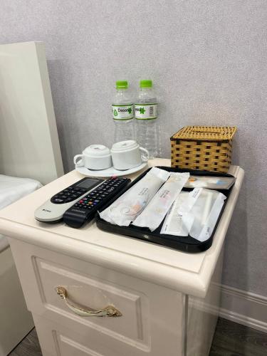 a white table with a remote control on it at Khách sạn Hướng Dương in Hanoi
