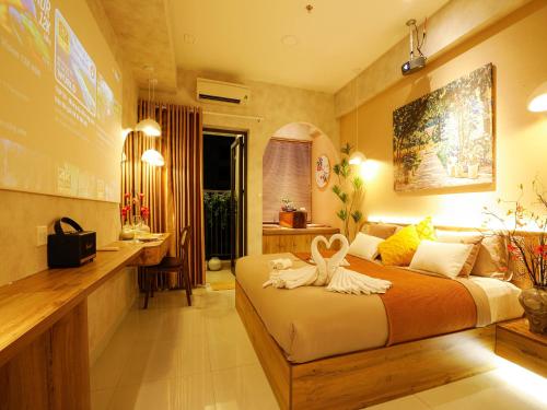 a bedroom with a bed with two towels on it at May Soho Saigon Serviced Apartment in Ho Chi Minh City
