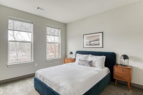 a bedroom with a bed and two windows at Burlington 1br w gym wd nr dining shops BOS-978 in Burlington