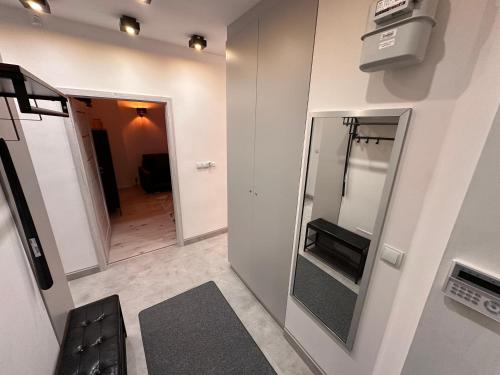 a room with a mirror and a hallway with a television at Aparthotel Zabrze, Apartament Agnieszka in Zabrze