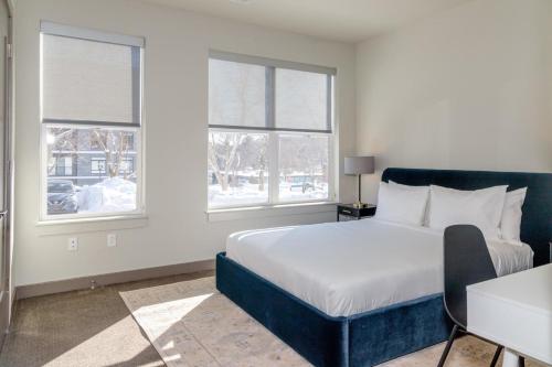 a bedroom with a large bed and two windows at Burlington 2br w gym wd nr dining shops BOS-977 in Burlington