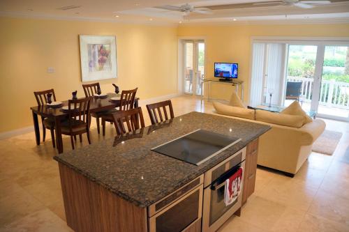 a kitchen and living room with a couch and a table at The Hamilton Beach Villas & Spa in Nevis