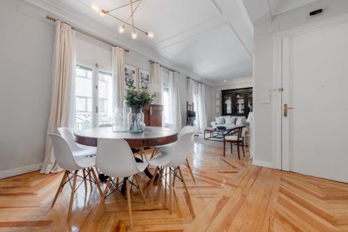 a dining room with a table and white chairs at Spacious bright- 2Bd 2Bth- Recoletos in Madrid